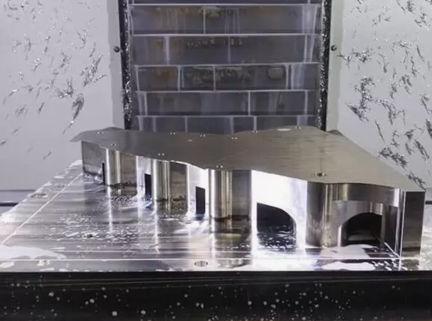 Machined metal component on a CNC machine table